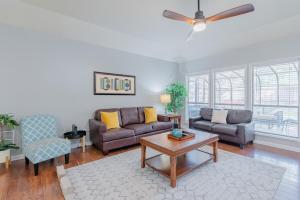 a living room with a couch and a table at Beautiful Home With Sunroom, Gameroom, Yard & Bbq in San Antonio