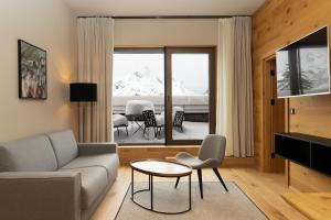 a living room with a couch and a table at Heimat 1495m Appartement TYP 3 in Schröcken