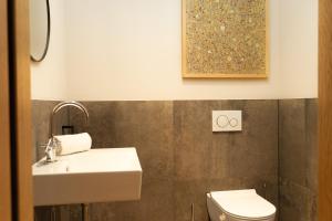 a bathroom with a sink and a toilet at Heimat 1495m Appartement TYP 3 in Schröcken