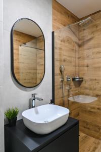 a bathroom with a white sink and a mirror at Luxury Villas Great Escape & Noa in Novalja