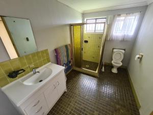 a bathroom with a sink and a shower with a toilet at Aspley bedroom & share bathroom with other guests in Brisbane