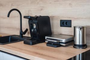 a kitchen counter with a coffee machine on a counter top at Luxury Villas Great Escape & Noa in Novalja