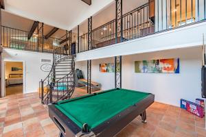 a pool table in a room with a staircase at Luxury House By Fiesta Texas & Seaworld With Pool in San Antonio