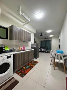 a kitchen with a washer and dryer in a room at Edusphere Suites, University of Cyberjaya near Tamarind Square in Cyberjaya