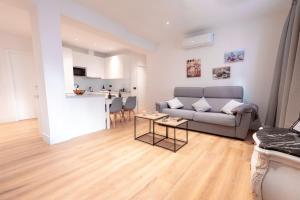 a living room with a couch and a kitchen at Zenete Terral Málaga in Málaga +45 photos