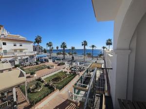 a view of the beach from a balcony of a resort at Spacious Front Line Beach 3 Bedroom apartment with amazing sea views a few steps from the beach in Benalmádena