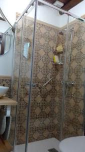 a shower with a glass door in a bathroom at Mi Casita - Higuera de la Sierra in Higuera de la Sierra