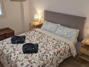 a bedroom with a bed with two bags on it at Spacious Front Line Beach 3 Bedroom apartment with amazing sea views a few steps from the beach in Benalmádena