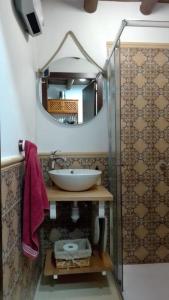 a bathroom with a sink and a mirror at Mi Casita - Higuera de la Sierra in Higuera de la Sierra