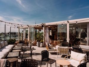eine Terrasse mit vielen Stühlen und Tischen in der Unterkunft Hobo Hotel Stockholm in Stockholm