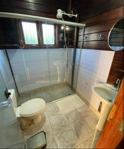 a bathroom with a toilet and a sink at Pousada Arara Canindé in Sao Jorge