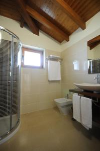a bathroom with a shower and a sink and a toilet at Villa 251 in Barcelos