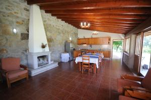 a kitchen and dining room with a table and a fireplace at Villa 251 in Barcelos