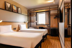 Postel nebo postele na pokoji v ubytování ibis Porto Alegre Aeroporto