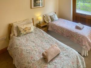 A bed or beds in a room at The Old Carthouse