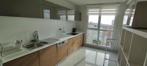 a kitchen with a sink and a large window at First Avenue Mall & Residence in Istanbul