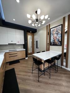 a kitchen with a table and chairs in a room at Villa Karakol in Karakol