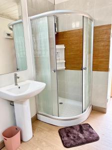 a bathroom with a shower and a sink at Marc Hotel Maesai in Ban Sam Mana