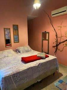 a bedroom with a bed with a red blanket at Pousada Babel in Rio de Janeiro