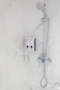 a shower with a shower head on a wall at Zenete Terral Málaga in Málaga