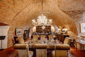 a dining room with a long table and a chandelier at Castello Di Casalborgone in Casalborgone