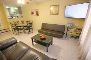 a living room with a couch and a large screen at Parque Santiago II 160 by Tenerife Rental and Sales in Playa de las Americas