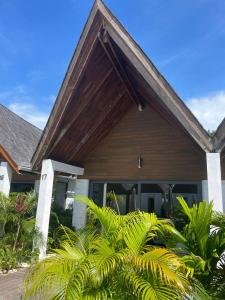 ein Haus mit Holzdach und einigen Pflanzen in der Unterkunft Golden Beach Resort in Koh Rong