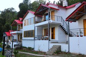 uma vista para uma casa com telhado vermelho em Hidden Trails Ramgarh, Nainital em Rāmgarh