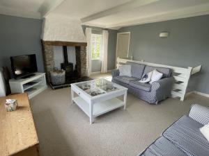 a living room with a couch and a coffee table at Little Crugsillick in Veryan