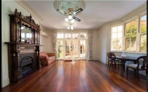an empty living room with a fireplace and a table at A peaceful room in Northbridge with free parking in Perth