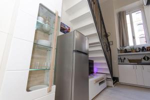 kuchnia z lodówką ze stali nierdzewnej oraz schody w obiekcie Appartamento Cadorna w Mediolanie