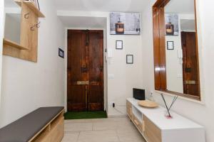 a bathroom with a mirror and a wooden door at Appartamento Cadorna in Milan