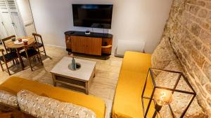 a living room with a couch and a table at Le Chouette Loft in Dijon +19 photos