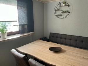 a dining room with a wooden table and chairs at Apartment Bella Petit in Rinderbügen