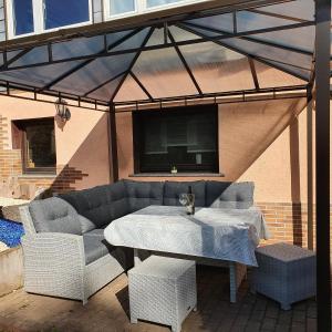 a patio with a couch and a table and chairs at Apartment Bella Petit in Rinderbügen