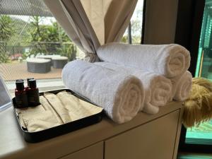 a tray filled with towels on a window sill at kMah@Parkland in Brinchang