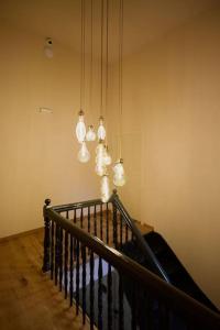a staircase with white lights hanging from a wall at Διαμέρισμα σε διατηρητέο κτίριο in Chalkida