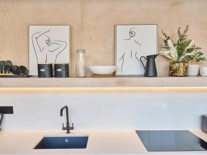 a shelf with two art prints and a sink at Host & Stay - Faversham Studio in Ramsgate