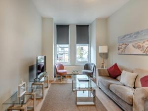 a living room with a couch and a tv at Apartment One - Uk45352 in Southport