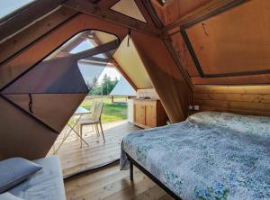 ein Schlafzimmer mit einem Bett in einem Holzhaus in der Unterkunft Poggio Imperiale Marche - Apartments & Glamping & Bubble Rooms in Civitanova Marche