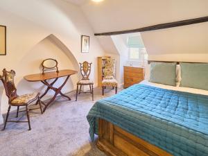 a bedroom with a bed and a desk and chairs at Host & Stay - St Radigunds House in Canterbury