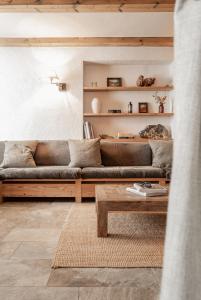 a living room with a couch and a coffee table at Berggasthaus & Lodge Resterhöhe in Mittersill