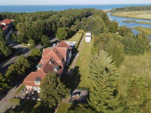 an aerial view of a house with trees and a river at Ferienhotel Alter Bahnhof garni in Prerow