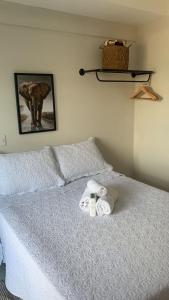 a bed with two towels and an elephant on it at FlatsRose SH Universitário PUC UFG HC 44 in Goiânia