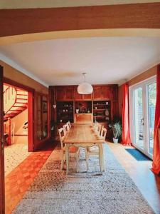 a dining room with a wooden table and chairs at Maison au centre de Kaysersberg in Kaysersberg
