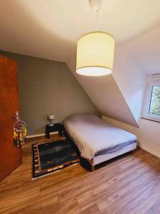 a bedroom with a bed and a ceiling at Maison au centre de Kaysersberg in Kaysersberg