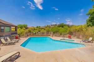 a large swimming pool with chairs at Pools / Hot Tub / 3 Bedroom Condo / Ventana Canyon in Tucson