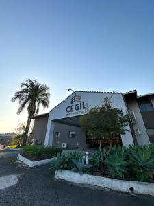 a building with a sign on the side of it at Cegil Hotel Boulevard in Resende