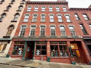 a large brick building with a store in front of it at Downtown Albany 1 Bed + Workstation @ Maiden Lane in Albany