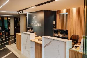 a lobby with a reception desk in a store at Hotel Serrano in Campina Grande